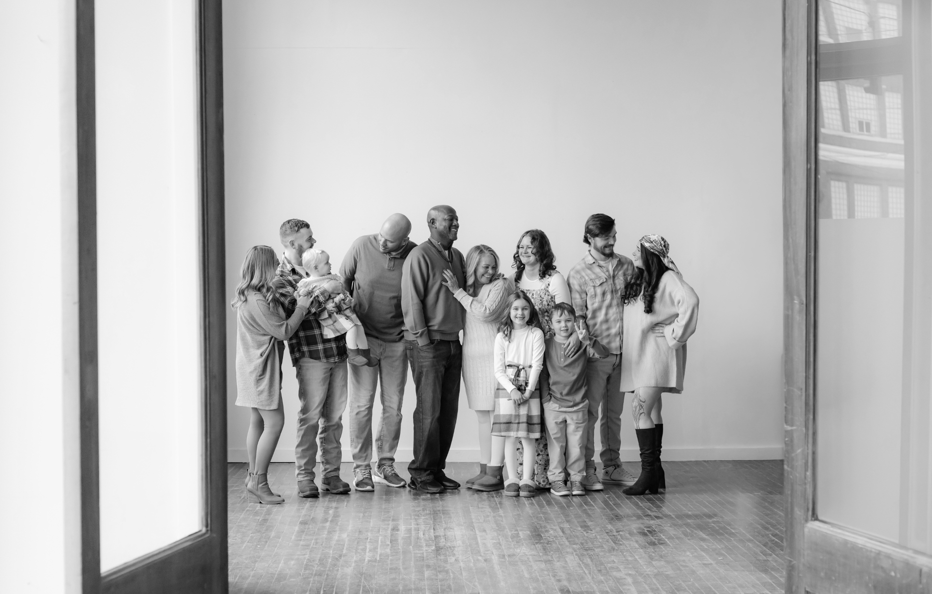 A large family group portrait in a bright studio